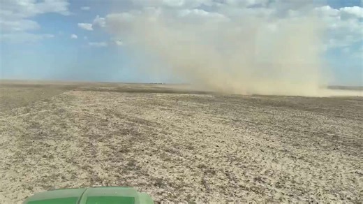 Dust devil swirls across dry farmland as weather shifts in Kansas, USA