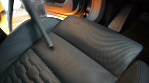 Man Vacuuming His Modern Car Seats and Interior