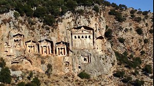 Lycian rock tombs in the rock, opposite Dalyan, Turkey. Tombs of the kings. Slow flight in a drone. 4K