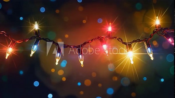 Video String of Christmas lights on a dark background, ideal for winter and holiday themed projects