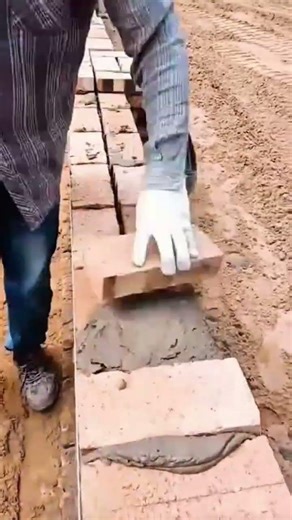 Applying a clean line of mortar on bricks using a specialized tool