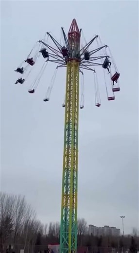 Long tower carousel swing ride breaks and collapses with people still in it