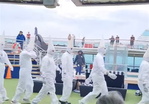 Passengers stunned as cruise workers appear on deck in Ku Klux Klan-like costumes