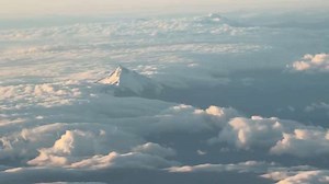 Aerial sunset view of snow-capped Mount Hood from flight in Portland, Oregon, USA