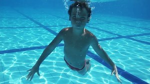 clip-14480113-young-boy-having-fun-underwater-pool