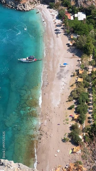 The pristine coastline and crystal clear waters of the Butterfly Valley in Oludeniz, Fethiye, Mugle, Turkey. The beach of the Valley of the Butterfly. A beach with fine white and soft sand. 4K