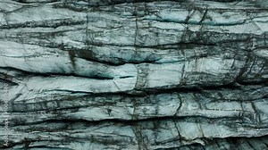 Top down aerial drone footage of Svínafellsjökull Glacier in Iceland, highlighting abstract ice patterns. Close up. Part 2.