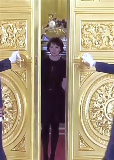 A young Russian woman looked overwhelmed with pride while being honored personally by President Putin, as smiles filled the Kremlin during the ceremony.