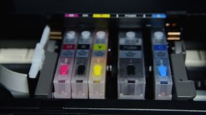clip-1040441690-refilling-ink-into-cartridge-inkjet-printer