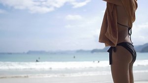 clip-18191722-girl-bikini-drying-herself-towel-beach