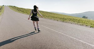 Woman in black short skirt riding on roller