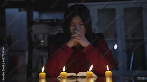 UHD 4k Slow motion B roll of young christian while praying and worship for Jesus. christian people praying while hands worship over a Bible. learning religion. Self worship of god. Low light shoot.