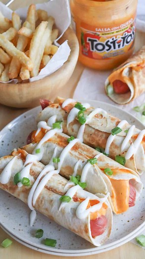 Hot Dog Taquitos ✨ Juicy franks snugly wrapped in tortillas, covered in cheese, and crisped to perfection. A fiesta for your taste buds and teenager approved! Ingredients: 6 hot dogs cooked 12 – 6 ” flour tortillas 1 cup Tex-Mex shredded cheese ½ cup queso or cheese sauce Crema or sour cream, garnish Green onion stalk diced for garnish Instructions: 1. Cook the hot dogs as desired. 2. Spray a large skillet with nonstick cooking spray. 3. Heat to medium-high heat. 4. Place a tortilla on the skill