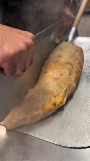 The steam coming off this GIANT calzone 🤤 📍: Burattino Brick Oven Pizza | Food Network