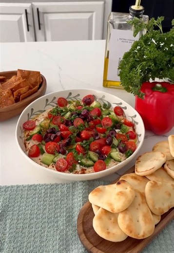 You have to try this 7-layer hummus dip appetizer 🙌 it’s so easy to put together and it’s definitely a crowd pleaser 👏🥗 💚 👉Shop bowl link in the bio (LTK) 💚🥗 Ingredients below 👇 1. Hummus (1-2 packets of store bought or homemade) 2. Feta crumbled 1/4-1/2cup (depends on how much feta you enjoy) 3. Chopped cucumbers 1/2 cup 4. Sliced cherry tomatoes 1/2 cup 5. Black olives pitted and sliced 1/4 cup 6. Parsley garnished on top 7. Olive oil drizzled 👉Optional: sprinkle of paprika 👉Tip: you
