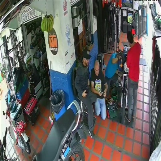 Mechanic Trips over Kneeling Colleague in Busy Shop