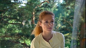 Frustrated, tired woman washes a window with the help of special brushes and sponges. Dolly shot.
