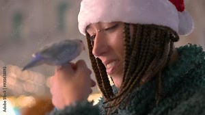 Woman bonding with bird at christmas market in slow motion