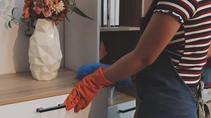 Download Woman cleaning a wooden table at home, hygiene and housekeeping concept, hands close up for free