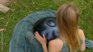 Beautiful female hands on a perfect musical percussion instrument.