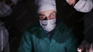 Doctors surgeons operate patient in operating theater. Surgical team performing operation in hospital operating room. Surgery on specialized clinic.