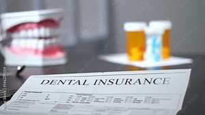 Focus pull on a dental insurance form sitting on dentist's desk.
