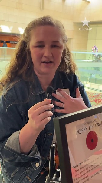 Visitors make poppies to honor Veterans Day at the National WWI Museum and Memorial