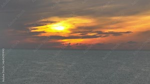 Each gentle undulation of the water's surface captures and reflects the early morning light, creating a mesmerizing dance of glimmers that ripples outward, like a symphony of nature in motion.