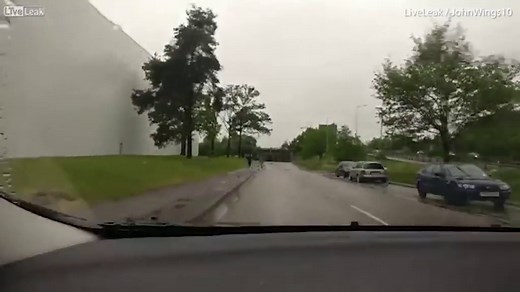 Driver speeds through huge puddle to splash men who hit his car