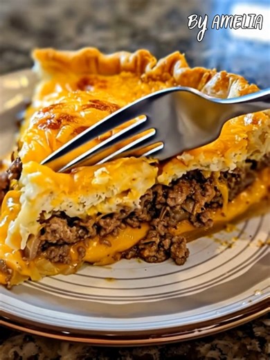 Homemade Cheeseburger Pie – A Family Classic Made Easy! Juicy ground beef, melty cheese, and a golden crust come together in this cozy, budget-friendly dinner. It’s like your favorite cheeseburger baked into a pie! Ingredients: 1 lb ground beef 1 medium onion, chopped 1 cup shredded cheddar cheese ½ tsp salt ¼ tsp black pepper 2 large eggs 1 cup milk ½ cup all-purpose flour 1 tsp garlic powder 1 tsp Worcestershire sauce (optional) Cooking spray or butter (for greasing pan) Instructions: Preheat 