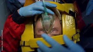 Paramedics proving first aid help to man. Doctors putting oxygen mask on patient