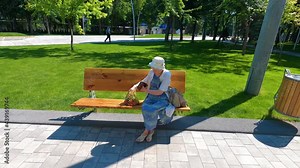 Female hands holding empty purse after shopping at park. Senior woman shows her empty wallet. Bankruptcy. The concept of poverty.