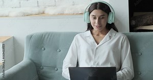 Online conference participant speaking and listening in virtual chat, remote job and working from home concept. Young woman studying online using laptop and video call with teacher and learning.