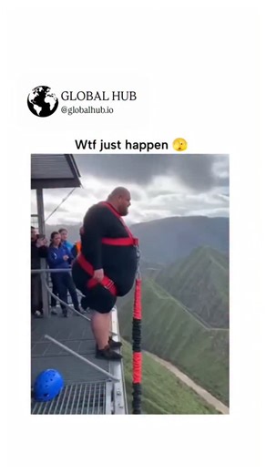 GLOBAL HUB on Instagram: "The video depicts an overweight man bungee-jumping from a cliffside platform over a grassy valley, landing on a star-shaped trampoline that creates a dramatic bounce amid dust clouds, drawing 7+ million views in under 12 hours for its apparent recklessness. Numerous replies flag it as AI-generated, highlighting anomalies like the unrealistically thin cord, physics-defying rebound, and inconsistent lighting, turning the thread into a discussion on spotting deepfakes in v