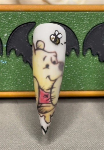 Something sweet is coming… 🍯🐝 I’ve been a bit quiet in the cave lately, but the Goblin brain has been busy. My newest set, Hunny Bee, is almost ready to emerge from the hoard. Inspired by the Hundred Acre Wood and a certain bear who loves his snacks. 🕯️✨ Hunny Bee releases tomorrow! Will you be adding her to your collection? 👇 #nailartist #pressonnails #winniethepooh #custompressonnails #trending