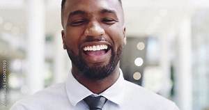 Face of laughing, confident and excited corporate worker standing in office. Portrait of a young business man happy and proud after a promotion. Professional success, achievement, goals attained