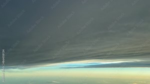 POV flying under a grey layer of stratus clouds shot from a jet cockpit. Immersive pilot perspective. 4K 60FPS