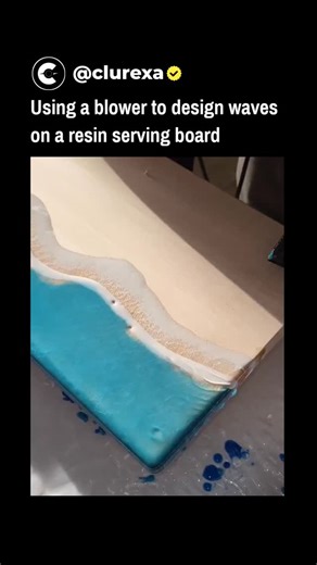 Clurexa on Instagram: "The post features a 19-second video demonstrating a resin art technique where a blower manipulates liquid epoxy on a wooden board to create lifelike ocean waves, blending blue resin for water and white for foam against a sandy base. Posted on 31 December 2025 by @awkwardgoogle , an account curating viral internet curiosities, the clip amassed over 5 million views and 46,000 likes within hours, sparking admiration for its satisfying fluid dynamics. This blower method, docum