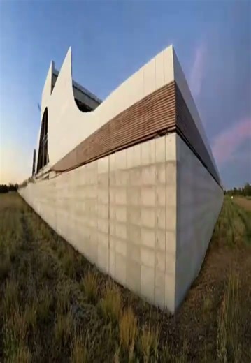 Futuristic Elevated Architecture with Illuminated Glass Facade