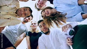 Low angle view Several people stand around and crouch to view the object below. People vie to be the first of curiosity