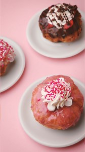 Our Valentine's Day Princess Doughnut will make you feel enchanted! 💖 A strawberry glaze, crowned with marshmallows, surrounded by whipped cream, and sprinkled with joy. Treat your taste buds to a royal celebration of romance! 👑🍩 Share the love and tag your sweetheart! #ParlorDoughnuts | Parlor Doughnuts