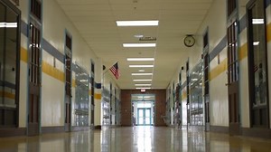 Empty hallway in high, middle, or elementary school with all the lights on.