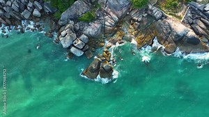 Drone video backdrop of sea wave in bird eye waves. Waves crushing on rocks on the beach.