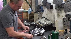 In this video, Clint explains how to install our precision cast aluminum pressure manifold block in the 47/48RE Valvebody. Common signs of a failing factory governor pressure solenoid are no up shifts, late up shifts, sticking in a gear, erratic shifting when cold and poor shift performance. In many cases a check engine light will come on indicating there is a transmission problem, often being caused be a failing governor pressure solenoid. Dodge uses a very cheep, problematic solenoid that is m