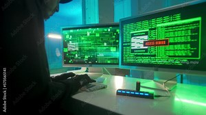 Hacker is typing on a computer keyboard and cracking a password. A man in a black hoodie, gloves and a headset. A green line of codes appears on the screen. Access denied, access granted.