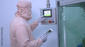 pharmaceutical worker using large machine in big pharma production machine. medicine packing machine. pills packing process. pharmaceutical manufacturing production line in a factory.