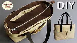 How to make a large zipper tote bag with multi-pockets. Material: Outer / Canvas 12 oz. (Light color) - 53 x 37 (20 7/8" x 14 1/2") 2 pcs - 59 x 25 cm (23 1/4" x 9 7/8") 2 pcs Outer / Canvas 12 oz. (Dark color) - 53 x 6 cm (20 7/8" x 2 3/8") 2 pcs - 39 x 8 cm (15 3/8" x 3 1/8") 2 pcs - 8 x 5 cm (3 1/8" x 2") 1 pc Linging / Cotton - 59 x 13 cm (23 1/4" x 5 1/8") 2 pcs - 53 x 33 cm (20 7/8" x 13") 2 pcs - 32 x 32 cm (12 1/2" x 12 1/2") 2 pcs - 39 x 8 cm (15 3/8" x 3 1/8") 2 pcs - 45 x 39 cm (17 3/