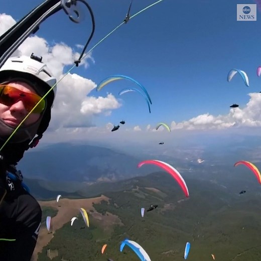 516K views · 32K reactions | FLYING HIGH: 150 pilots from 48 countries glided through the sky over North Macedonia, creating a mesmerizing display as they competed in the 16th World Paragliding Championship. https://abcn.ws/31JdCUG | ABC News | Facebook