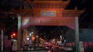 Zoomed in footage showing traditional oriental architectural details of the red paifang arched gate over road entrance to Chinatown, Montreal, Canada.