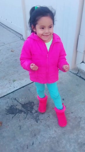 Child Strolling in Bright Outfit on Urban Sidewalk